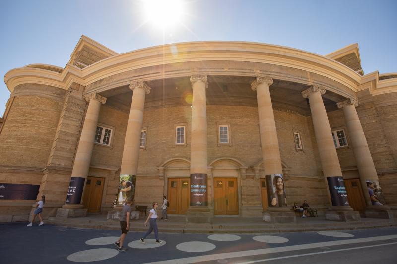 Front view of Convocation Hall with sunshine above.