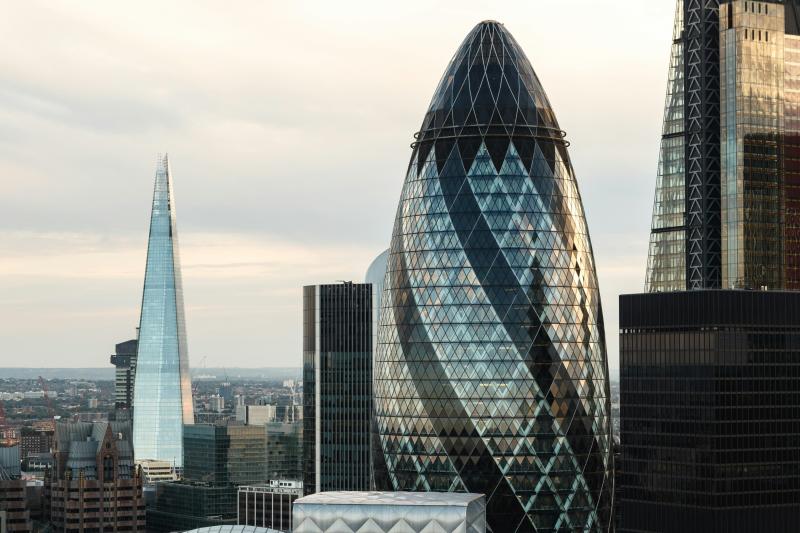 View of London at sunrise. Several corporate buildings are visible including the Gherkin and the Shard