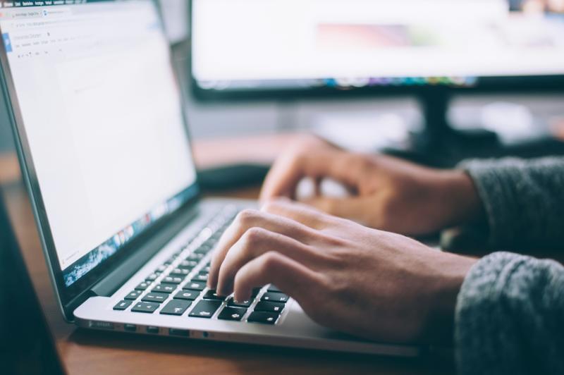 A person typing on the computer keyboard