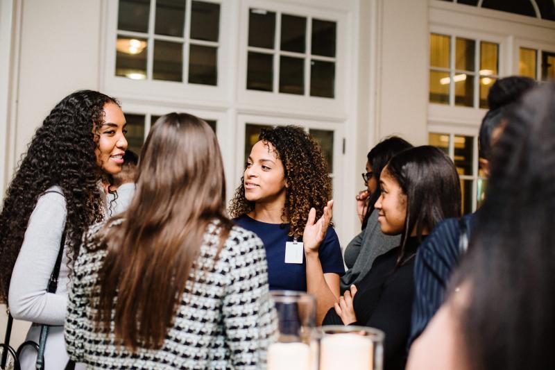 alumni talking to each other at event