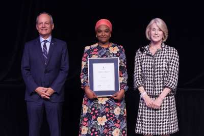 A recipient holding their award