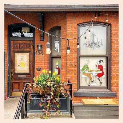 A restaurant with an illustration by Alanna Cavanagh on the window. 