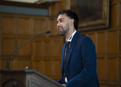 A man speaking into a microphone on a stage
