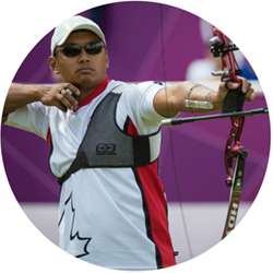 Crispin Duenas loosing an arrow from his bow.