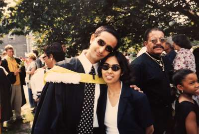 Cynthia and Anil at graduation, in their robes