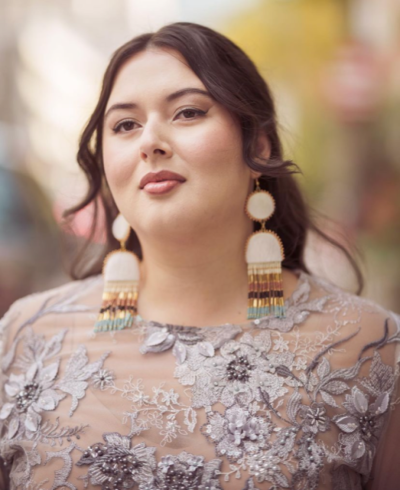 Lesley Hampton looking into the distance, wearing large drop earrings