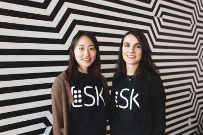Livia Guo and Seray Çiçek stand together, wearing sweatshirts with the text, LSK.