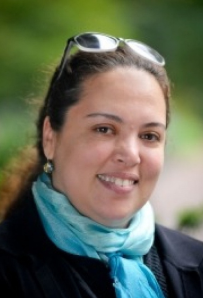 Maria Assif: a young woman with brown hair and light skin, smiling.