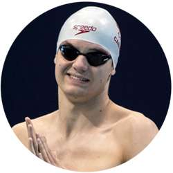 Portrait of Matt Cabraja smiling in swimming hat and goggles.