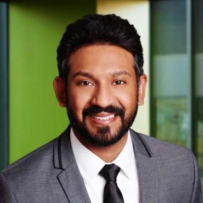 Speaker, Niro Kandasamy, man in suit smiling in portrait