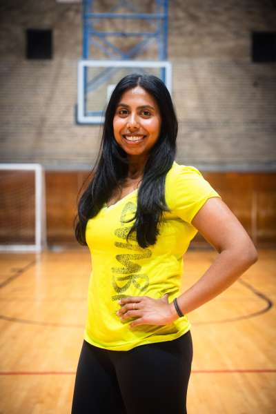 Sandani Hapuhennedige stands in a gym smiling.
