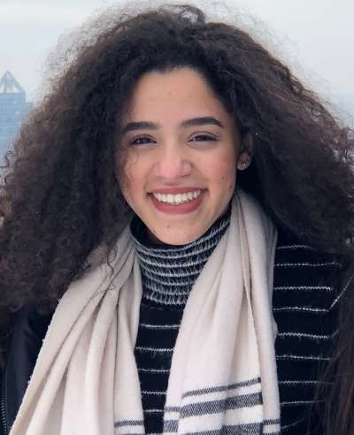 Portrait of Reem El-Ajou smiling.