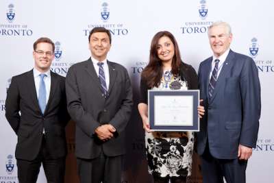 Samra Zafar holds an award certificate and poses with dignitaries Matthew Chapmen, David Naylor and Michael Wilson in 2013.