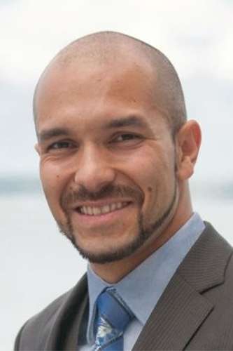 Portrait of Santiago Luna smiling.