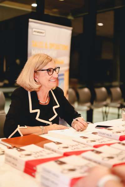 Susan signing her book at an event.