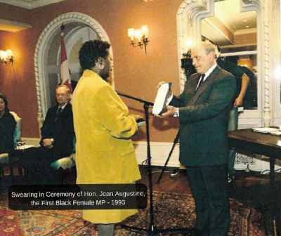 Jean Augustine facing a man on stage at her swearing in ceremony 