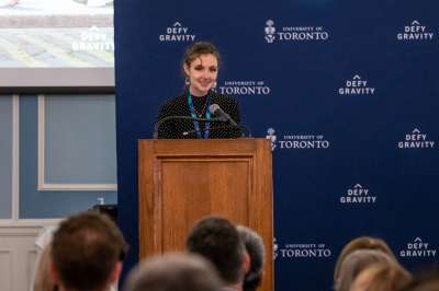 Lucy standing at a podium