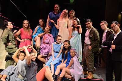 The actors in the play Trojan Barbie wear colourful costumes in Ancient Greek style.