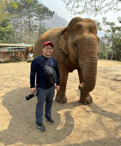 Choi standing with an elephant