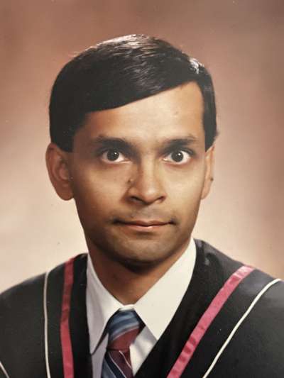Portrait of Vivek Goel as a young man in the 1980s, looking serious.