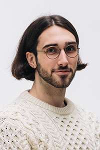 Portrait image of Aiden Gomez smiling.