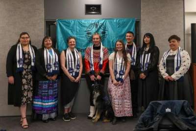 Alicia Corbiere posing for a group photo with other graduates 