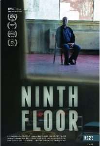 A man sits alone on a chair in the middle of a battered-looking room. Text reads: Ninth Floor.