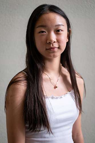 Portrait of high school student Orelia Pi smiling.