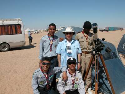 Ralph Chou standing outside in Libya with a group of boy scouts