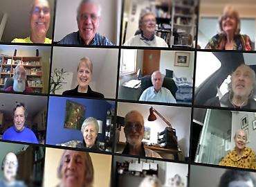 A grid of images shows alumni, each on a computer at home, chatting in a virtual meeting.