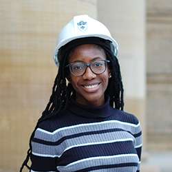 Valerie Ajayi smiling and wearing a hard hat.