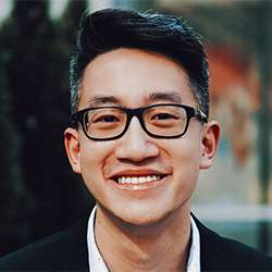 Portrait of Vincent Tang smiling.