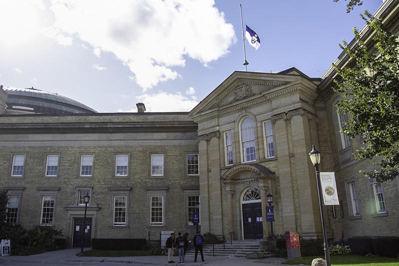 The University of Toronto flag flies at half mast on the roof of Simcoe Hall on Front Campus.