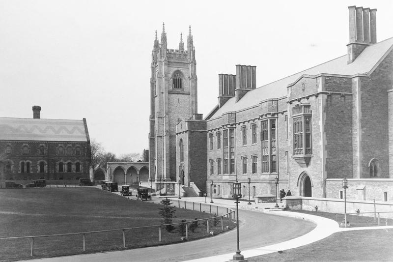 An archival photo of Hart House in 1925 shows no ivy, a treeless lawn, and Model-T Ford cars in the driveway.
