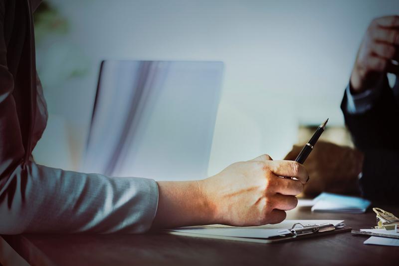 Photo of hand tapping pen on desk by rawpixel.com on Unsplash