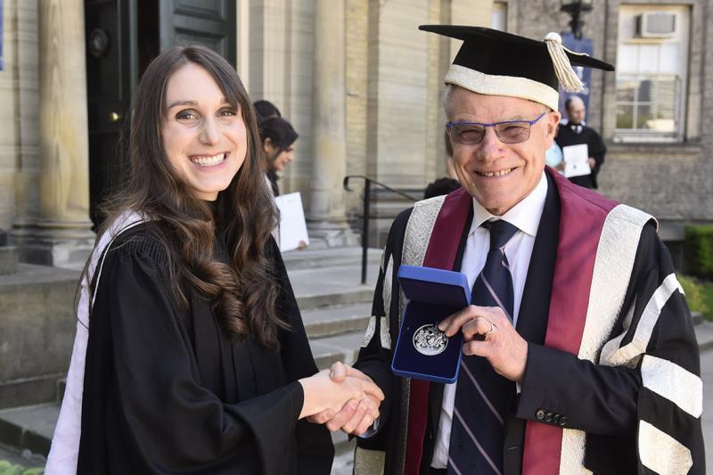 Olivia Rennie is congratulated by U of T Scarborough Principal Bruce Kidd
