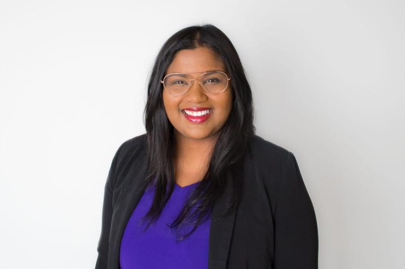 Portrait of Anjum Sultana smiling.