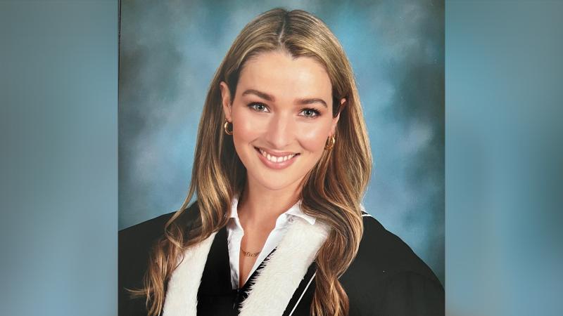 Annie Clark smiles in a formal graduation portrait.