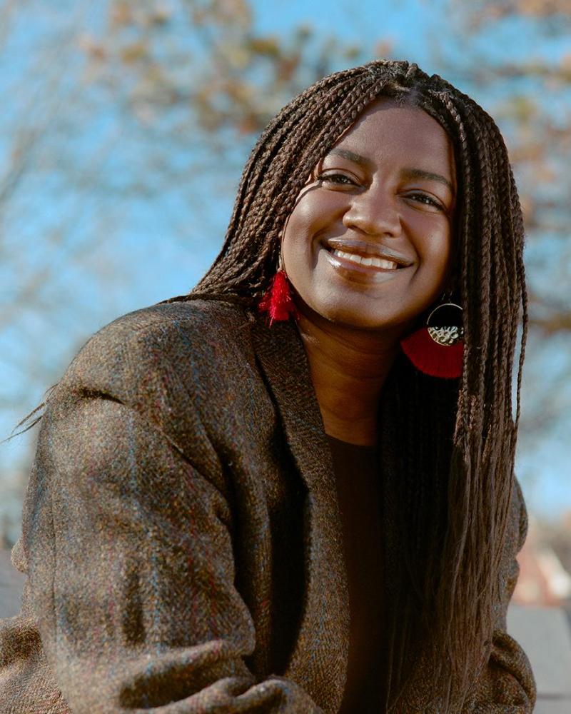Portrait image of Tea Mutonji smiling.