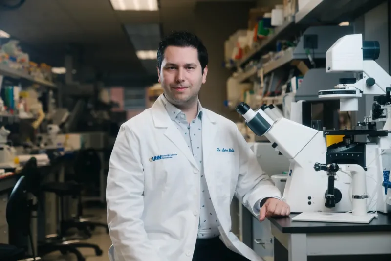 Brian in a lab wearing a white coat