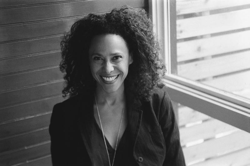 Photo of Beth Coleman smiling by a window.