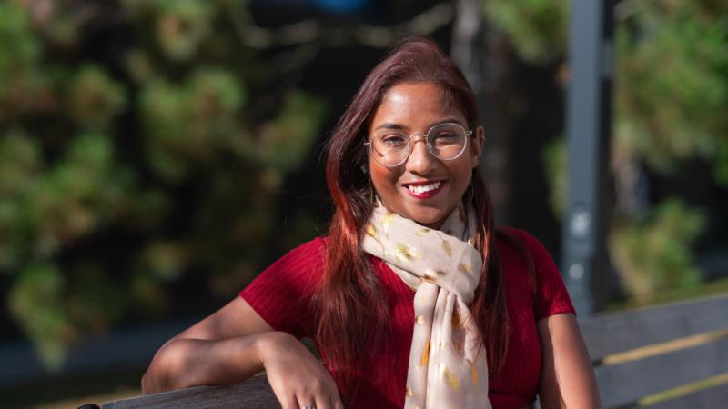 Portrait of Rashmi de Silva Wijeyeratne sitting on a bench