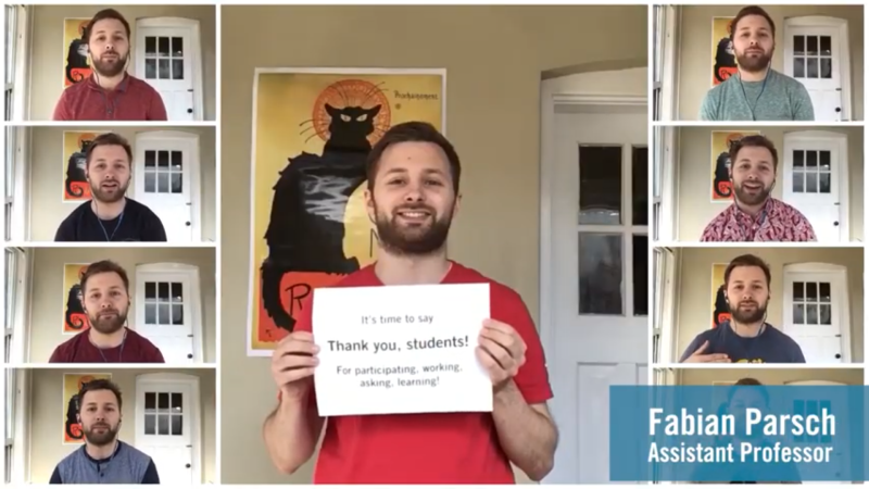 Fabian Parsch holds up a sign to the camera reading: Thank you students, for participating, asking, working, learning.