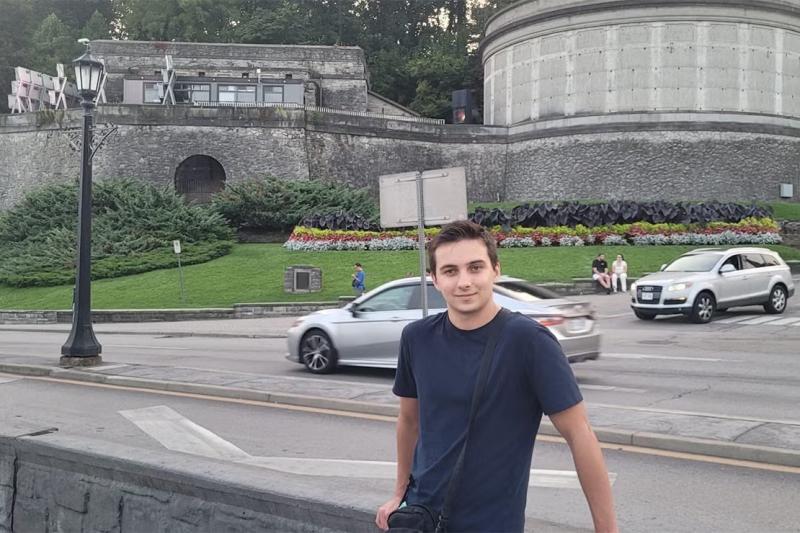 Rahul Kalvapalle posing outdoors in front of a road