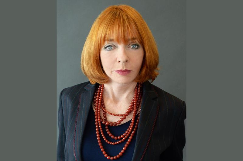 Portrait of Gloria Epstein looking serious.
