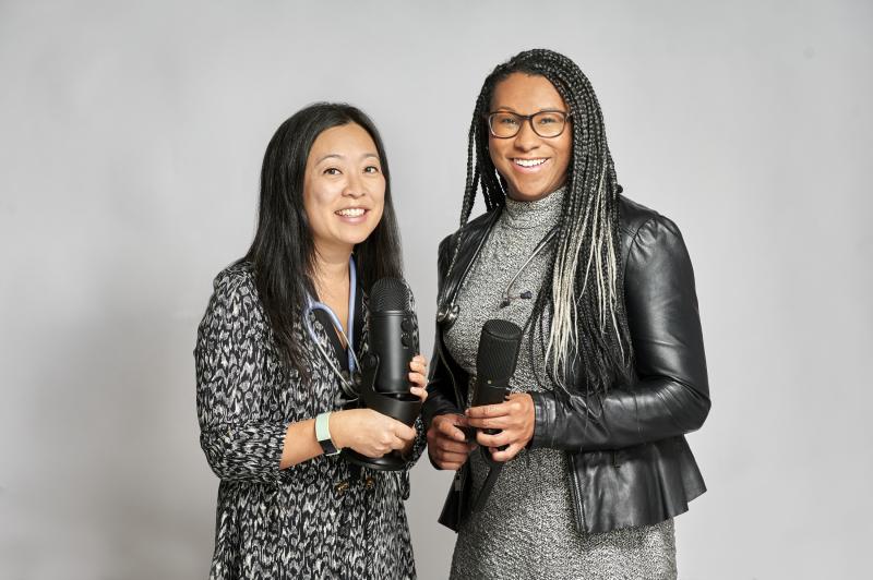 Two women holding microphones