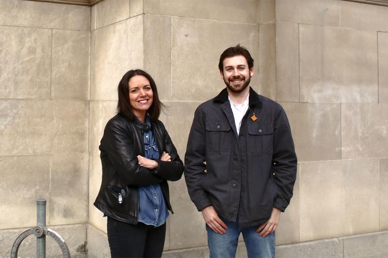 Darlee Gerrard and Ethan Boyer stand outside a building, smiling.