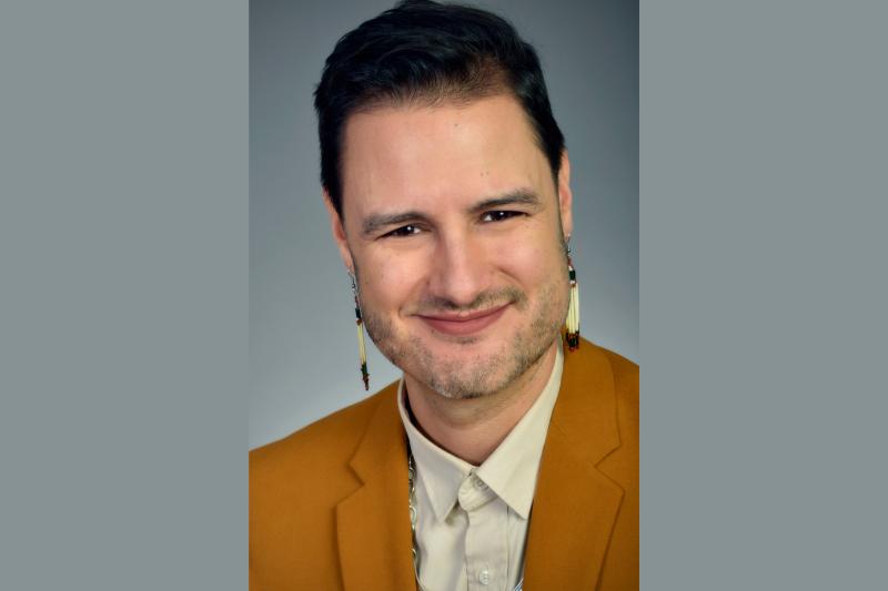 Portrait of John Hampton smiling.