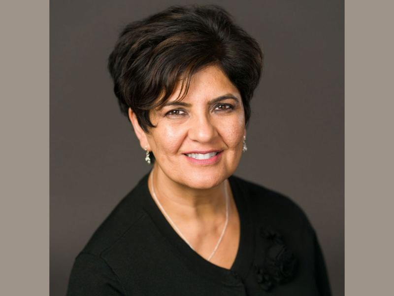 Formal portrait of Karima Velji smiling.