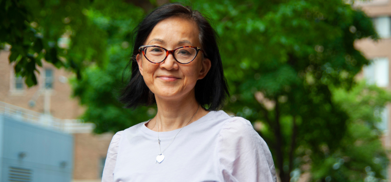 Laura Tam smiling in a garden.